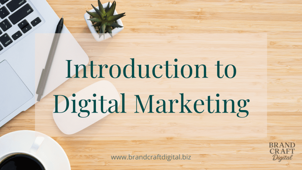 Flat lay of laptop, plant, and coffee cup on a wooden desk — workspace for a digital marketer working from home