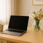 Woman working from home at a cozy desk with laptop and coffee.